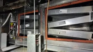 Clean commercial kitchen pollution control unit (PCU) with metal filters and ductwork after professional exhaust power washing