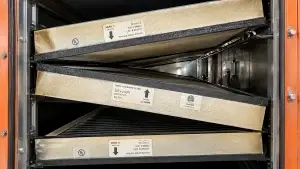 Grease-covered commercial kitchen exhaust filters prepared for professional hood cleaning and NFPA 96 kitchen exhaust maintenance