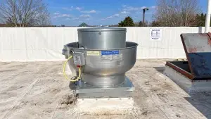 Rooftop commercial kitchen exhaust fan on a restaurant roof for professional exhaust system cleaning and maintenance