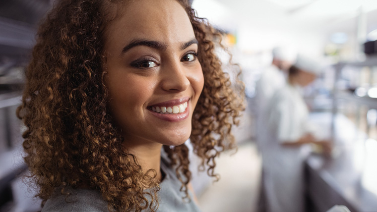 Woman smiling because the kitchen is grease free